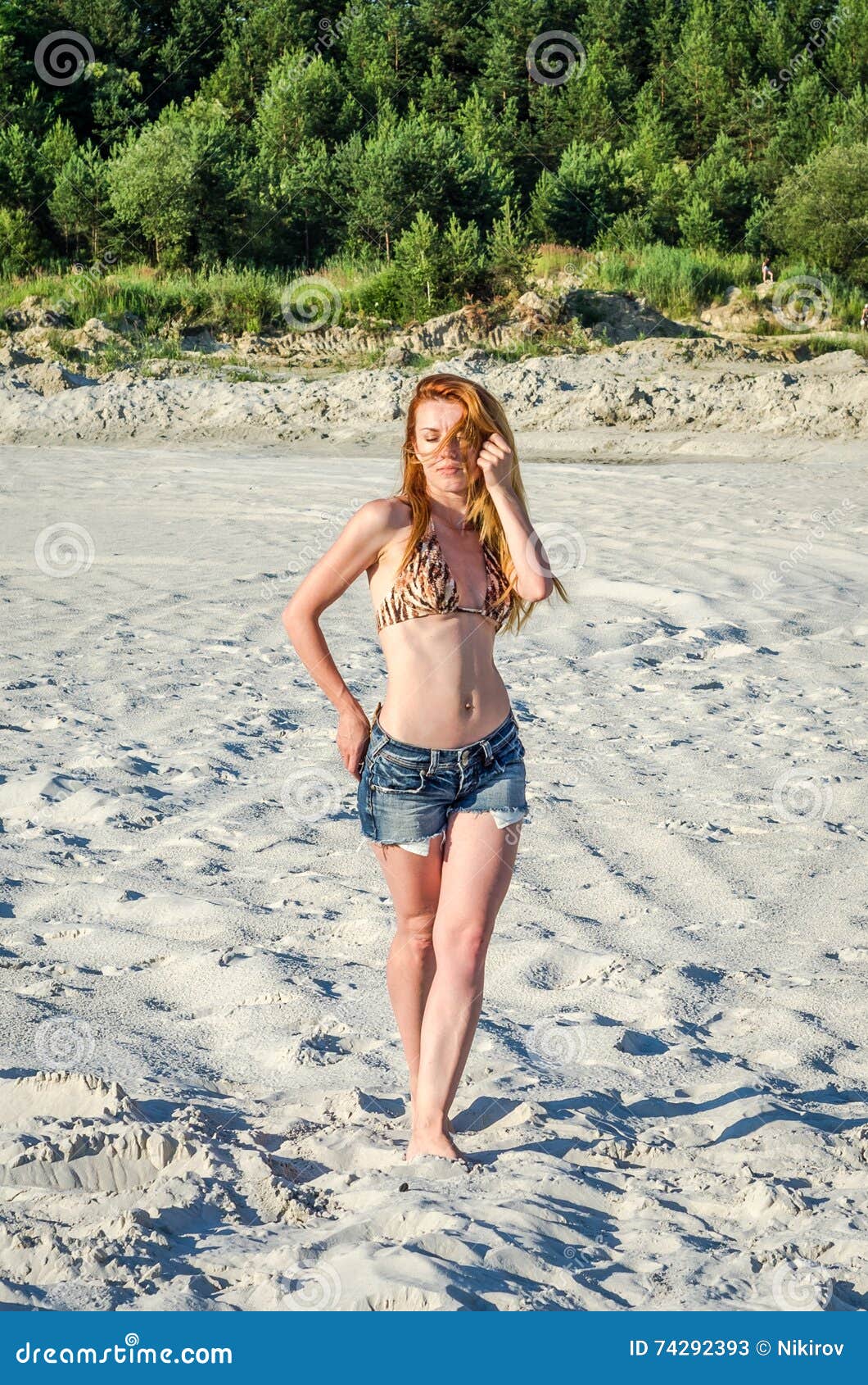 Young Charming Girl in Short Denim Shorts and Bikini Swimsuit with Long Hair  Walking Along the Sand Quarry Sand Extractive Stock Image - Image of long,  dune: 74292393