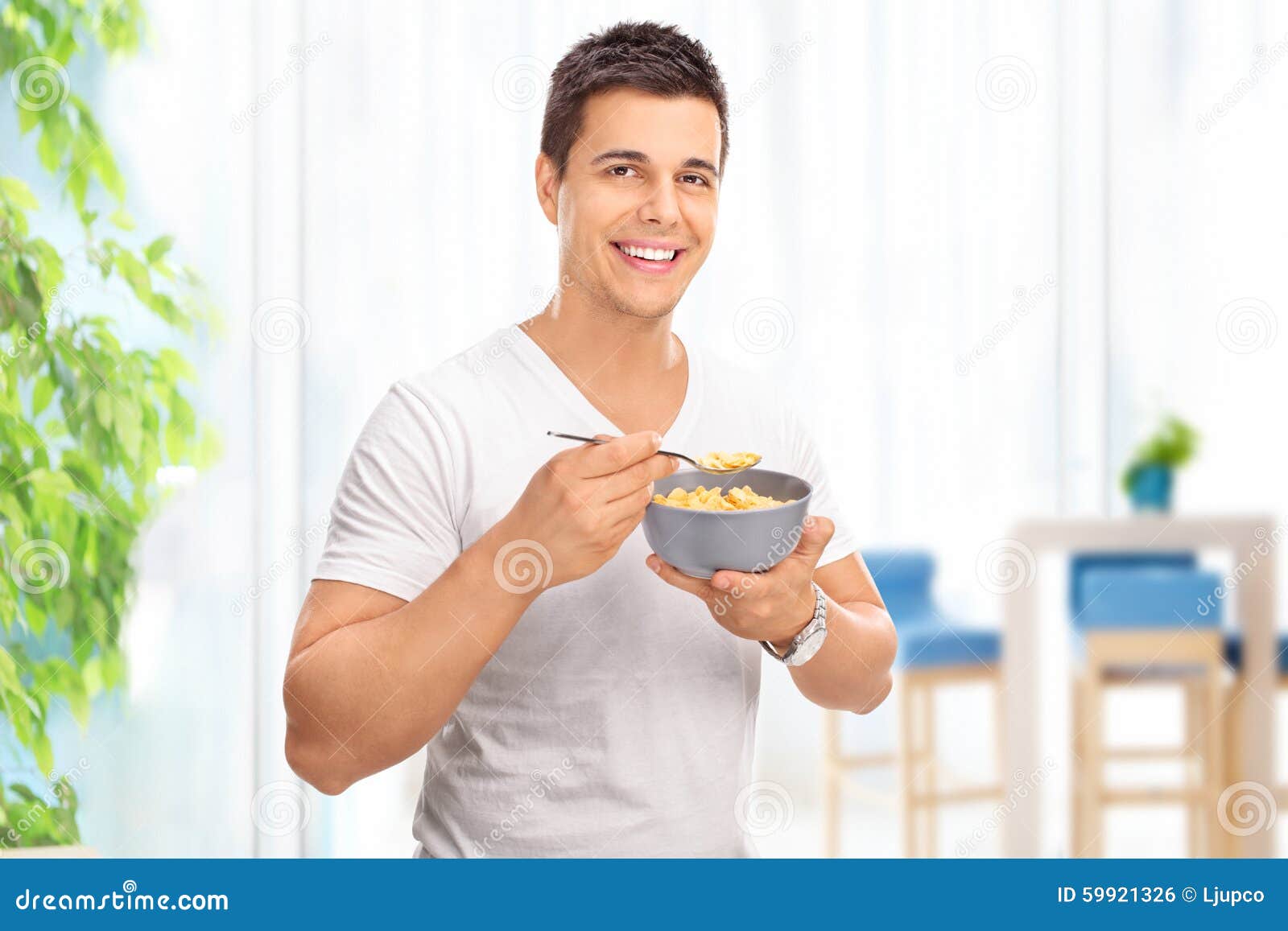 Young Cheerful Man Eating Cereal from a Bowl Stock Photo Image of