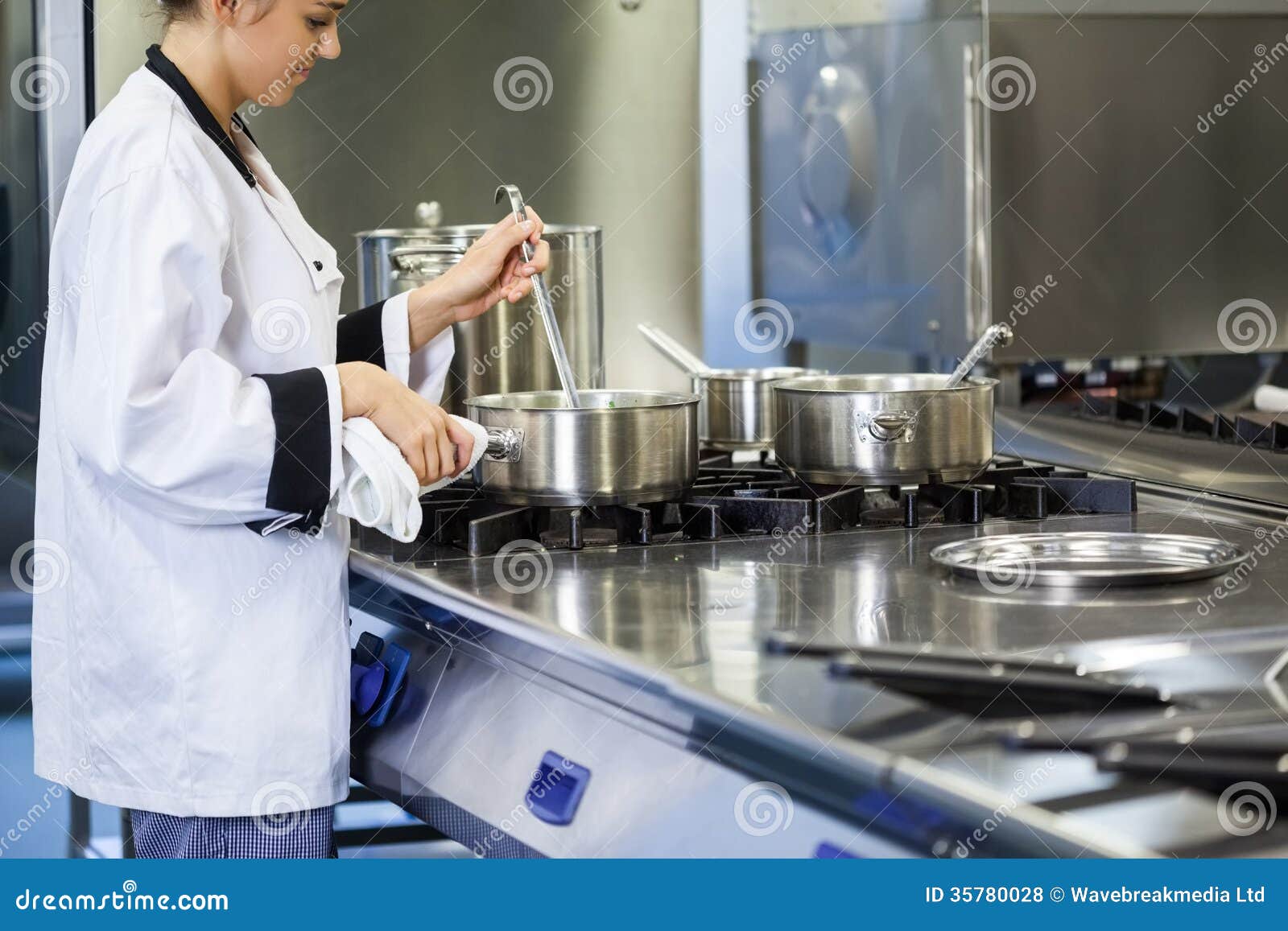 Young Chef Stirring with Ladle Stock Photo Image of person, stove