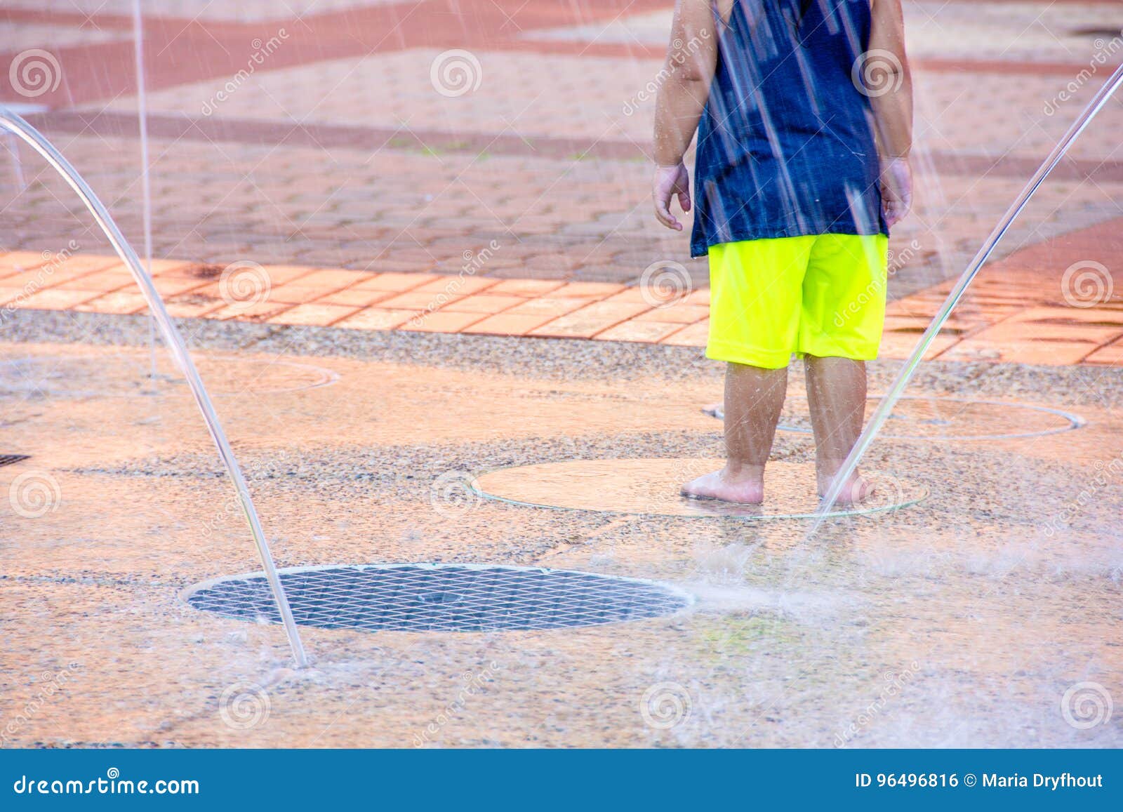 young child in city splash pad