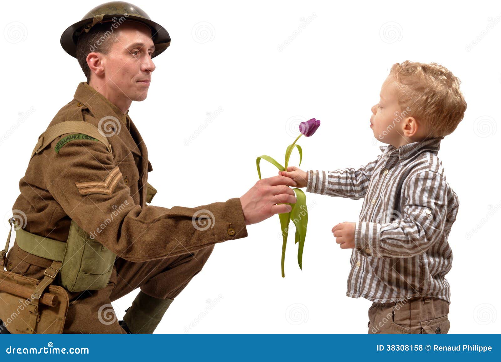 a young child gives a flower to a british soldier