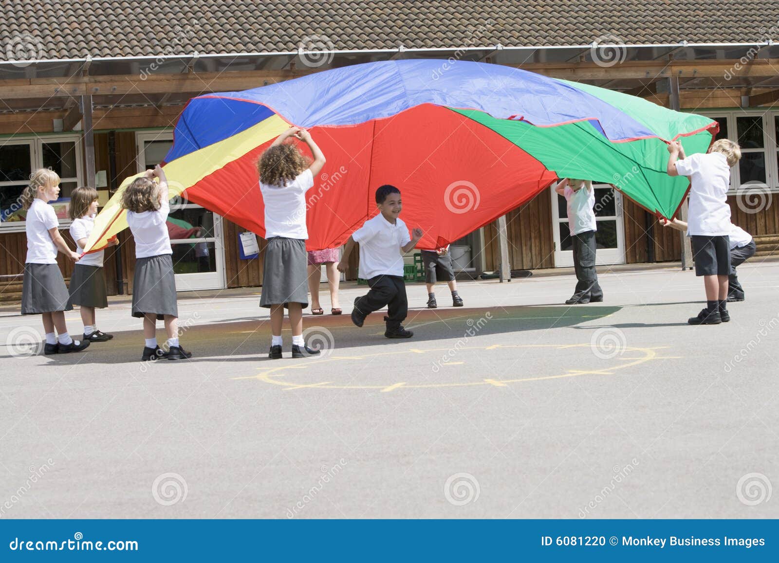 Young Children Playing with a Parachute Stock Photo Image of color