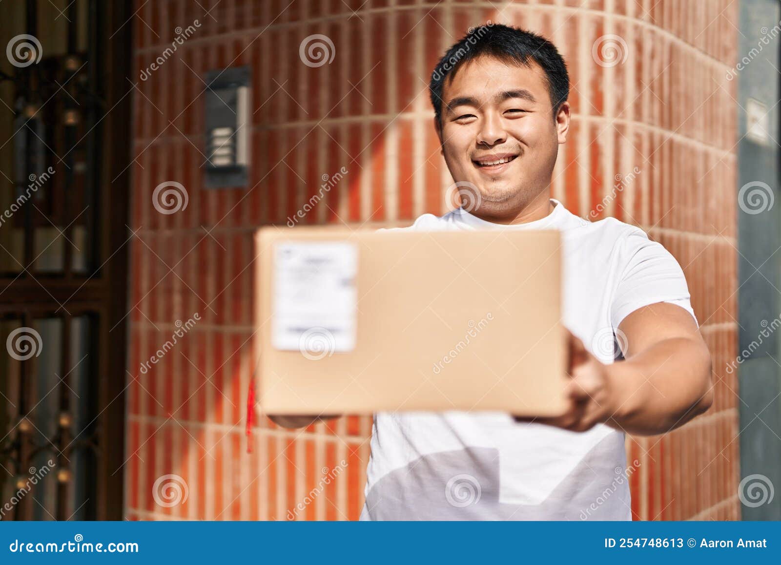 Young Chinese Man Courier Holding Package at Street Stock Image Image