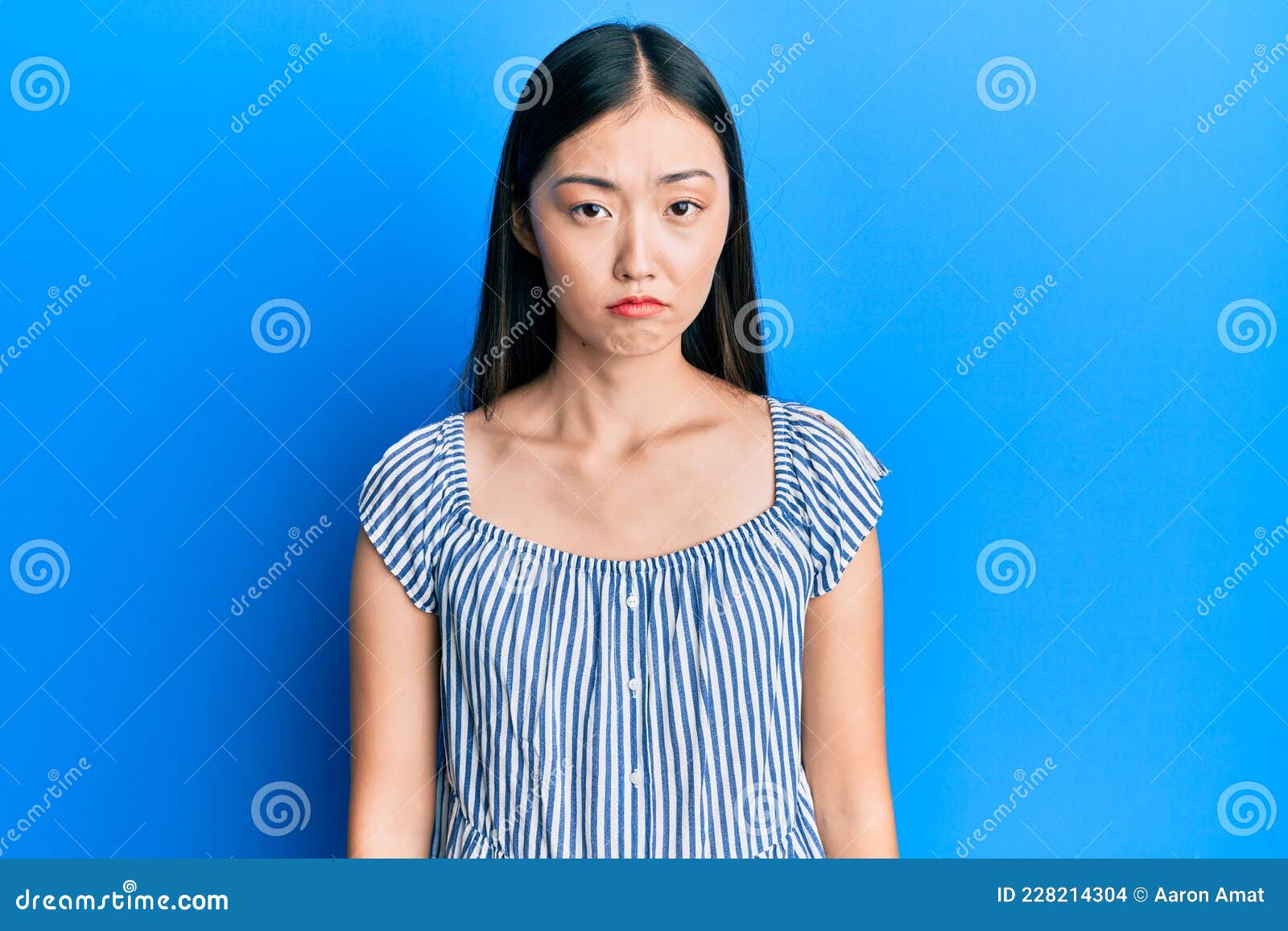 Young Chinese Woman Wearing Casual Striped T-shirt Depressed and Worry ...