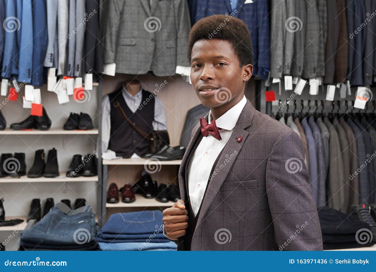 African Man Posing in Boutique in White Shirt, Stylish Suit. Stock ...