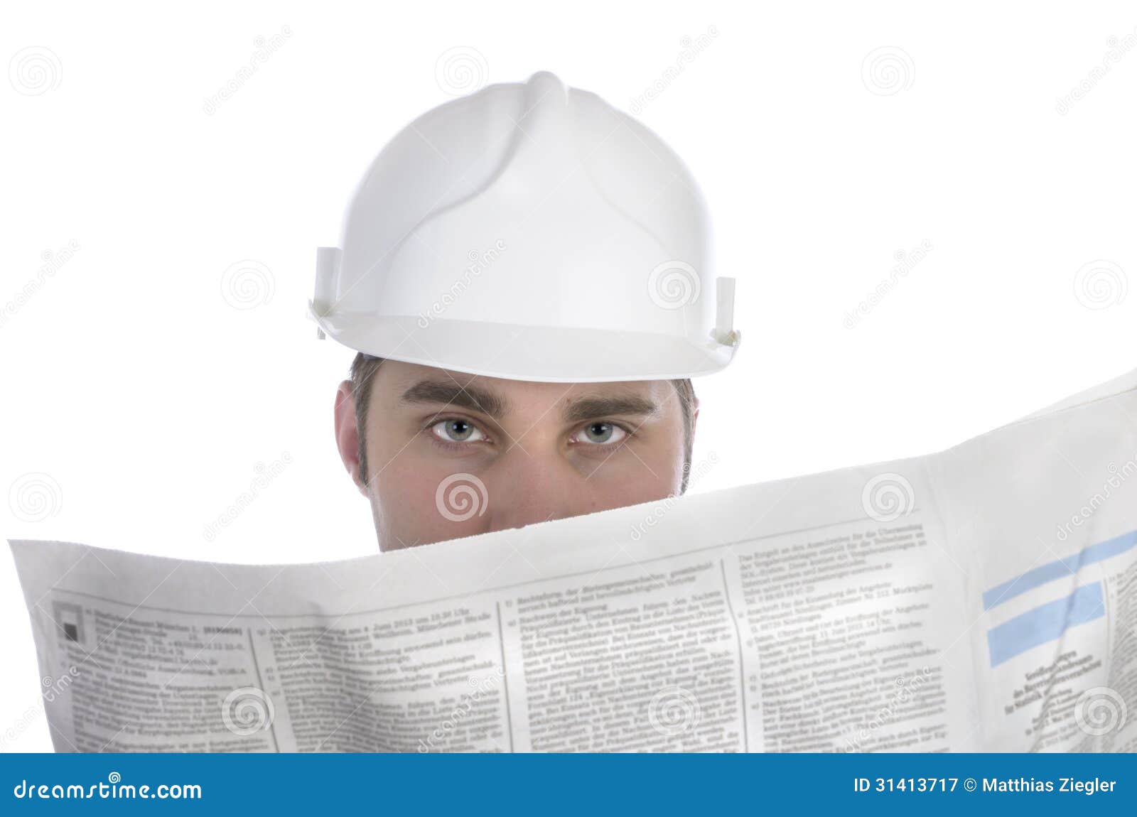 Young Construction Worker Studying Newspaper for Jobs Stock Image