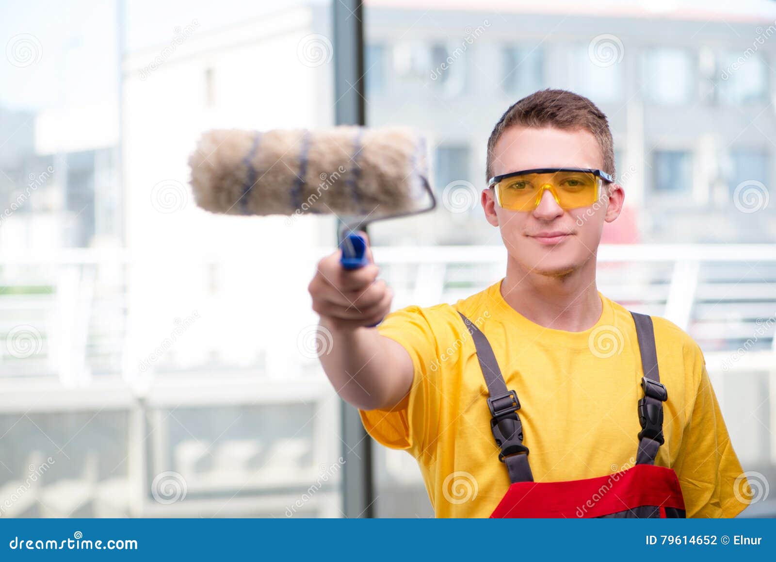The Young Construction Worker in Yellow Coveralls Stock Photo Image