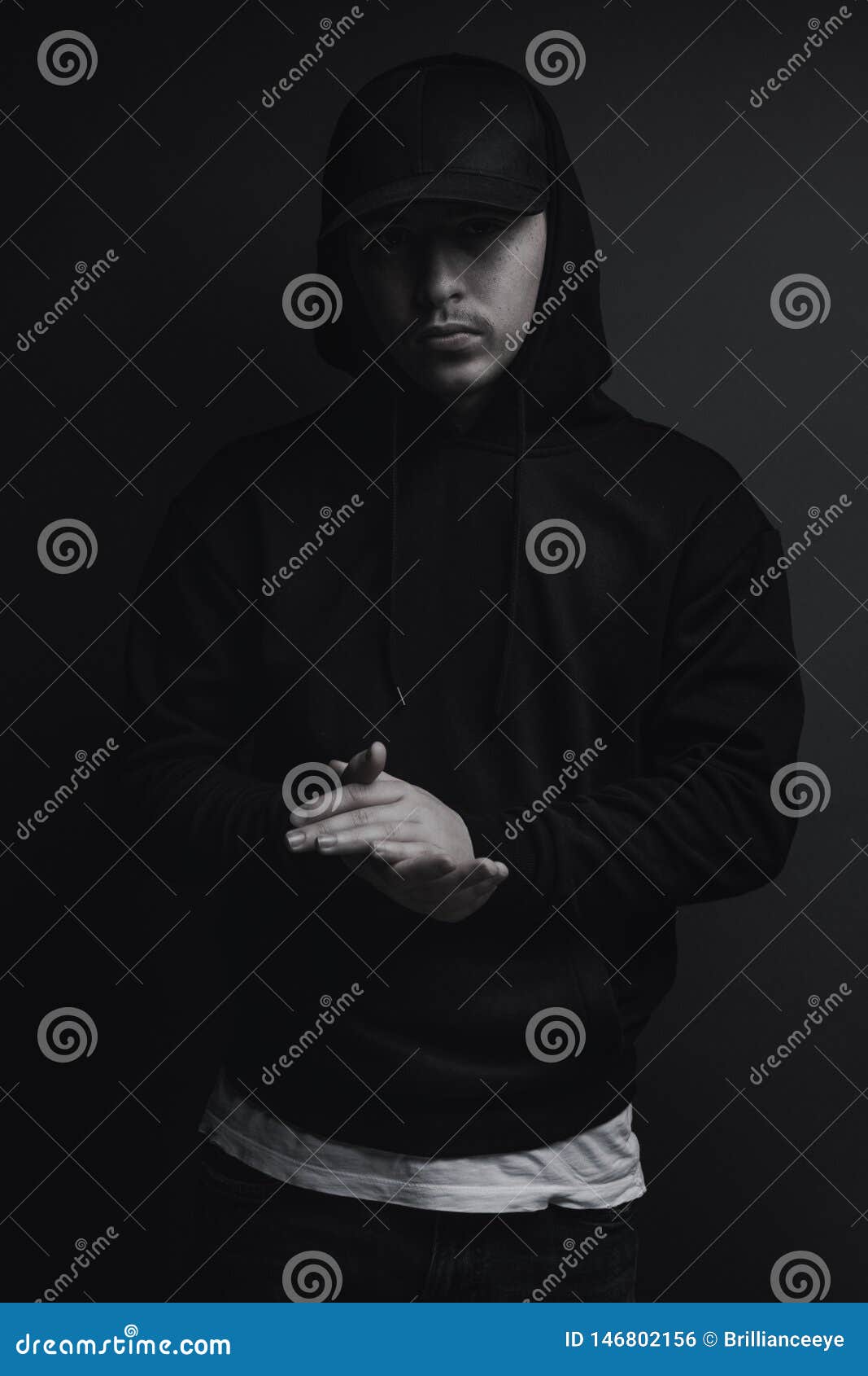 Young Cool Rapper with Black Hoodie and Cap Clap His Hands in Front of Grey  Background Stock Photo - Image of casual, light: 146802156