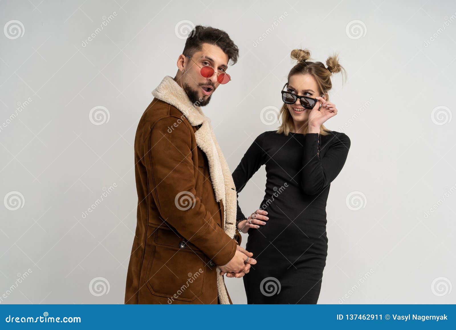 Young Couple Of Bearded Man In Coat And Pretty Woman In Black