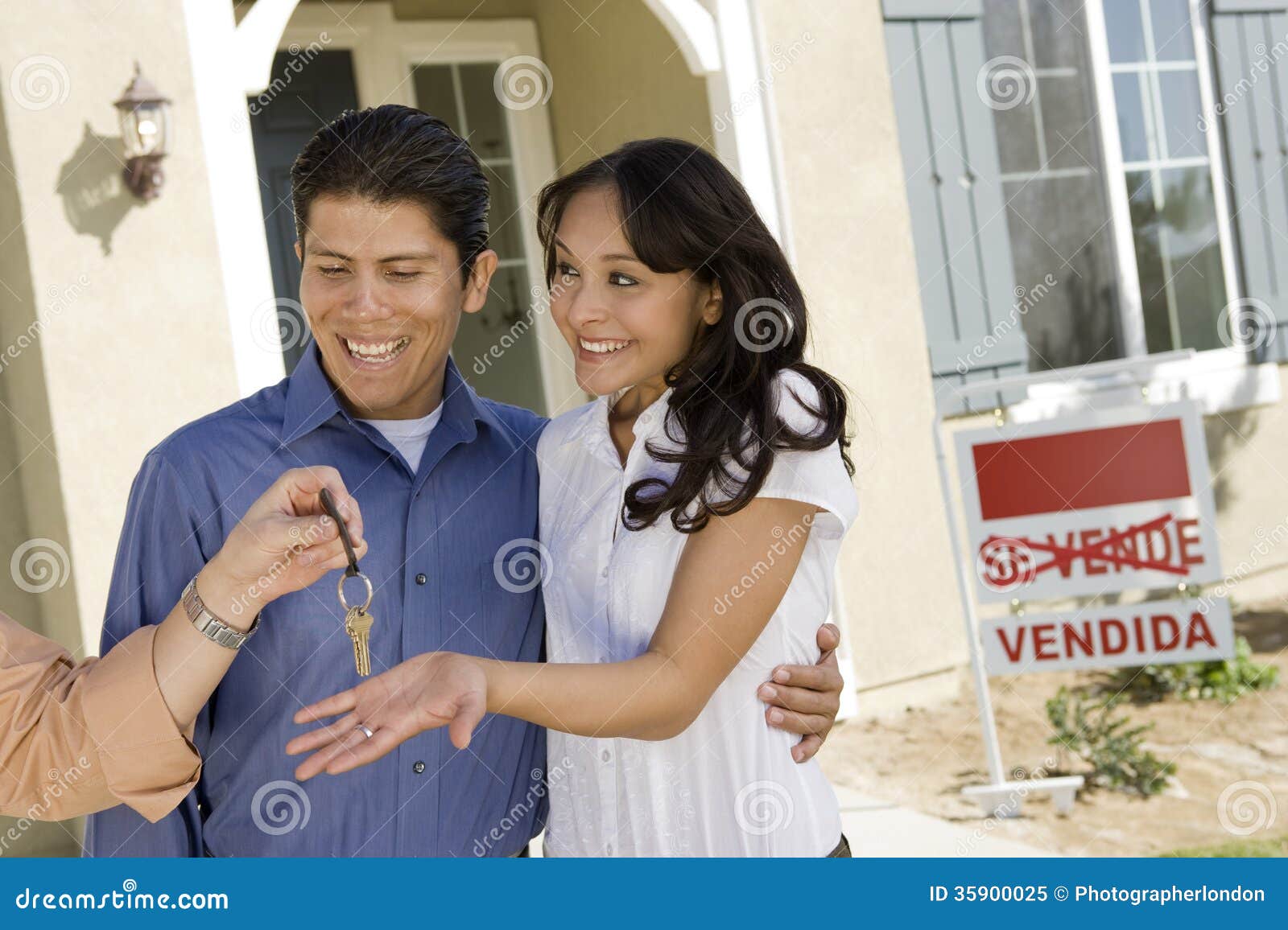 young couple buying house taking keys