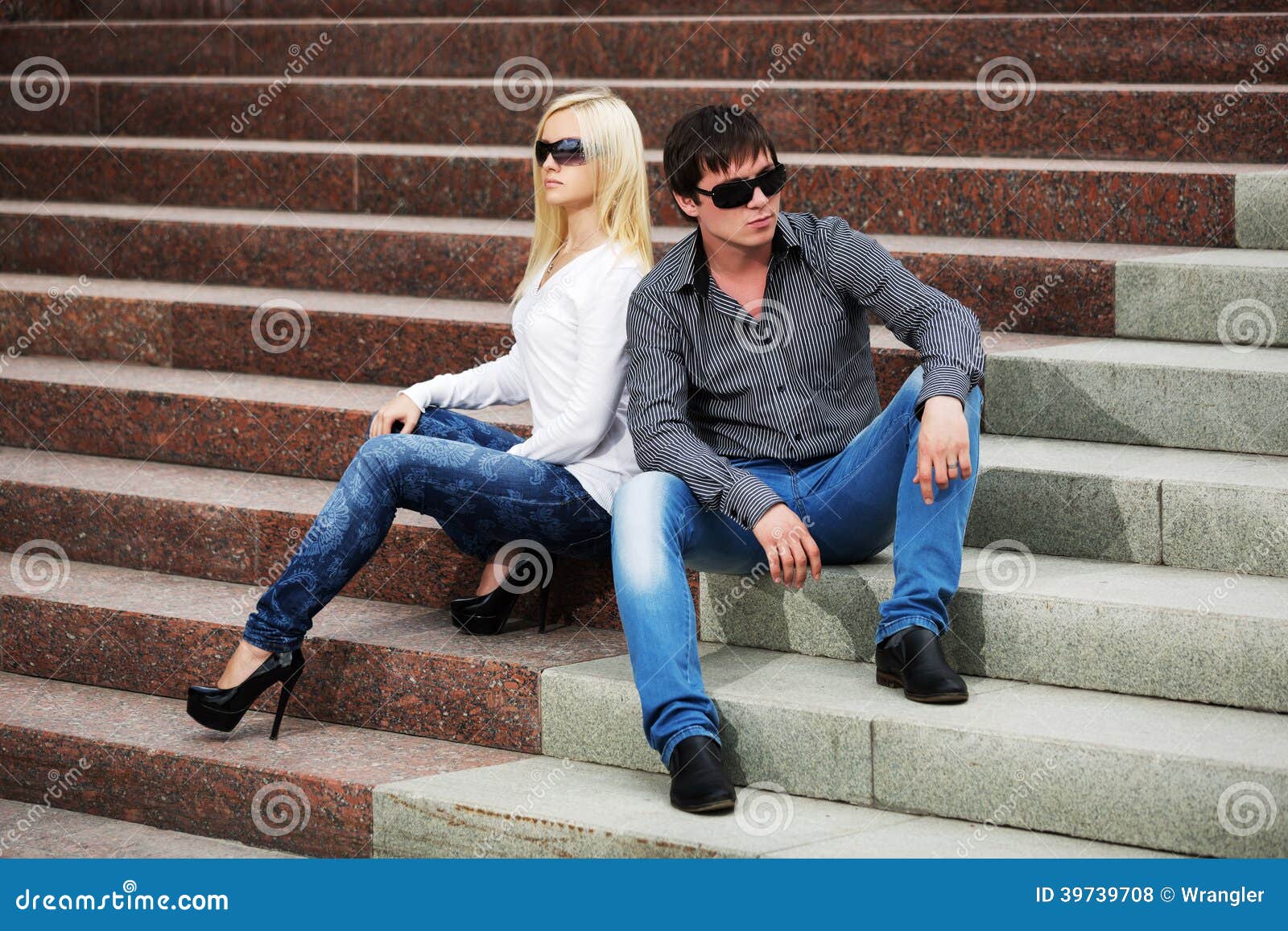 Young Fashion Couple In Conflict Sitting On The Steps 