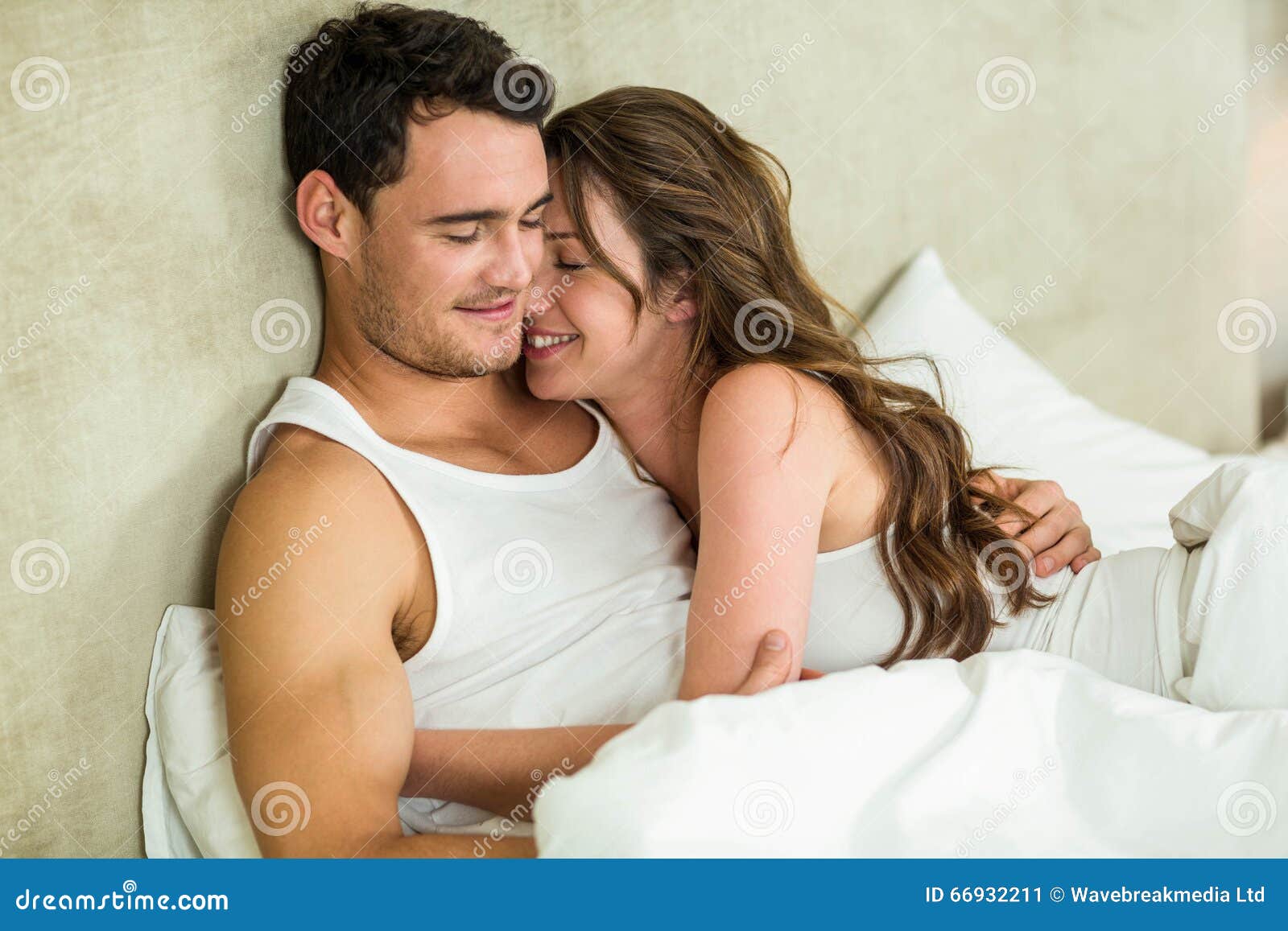 Young Couple Cuddling On Bed Stock Photo Image 66932211 Young Couple Cuddling On Bed Stock Photo Image 66932211
