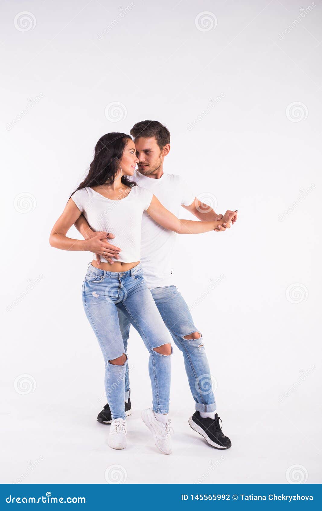 young couple dancing social latin dance bachata, merengue, salsa. two elegance pose on white background