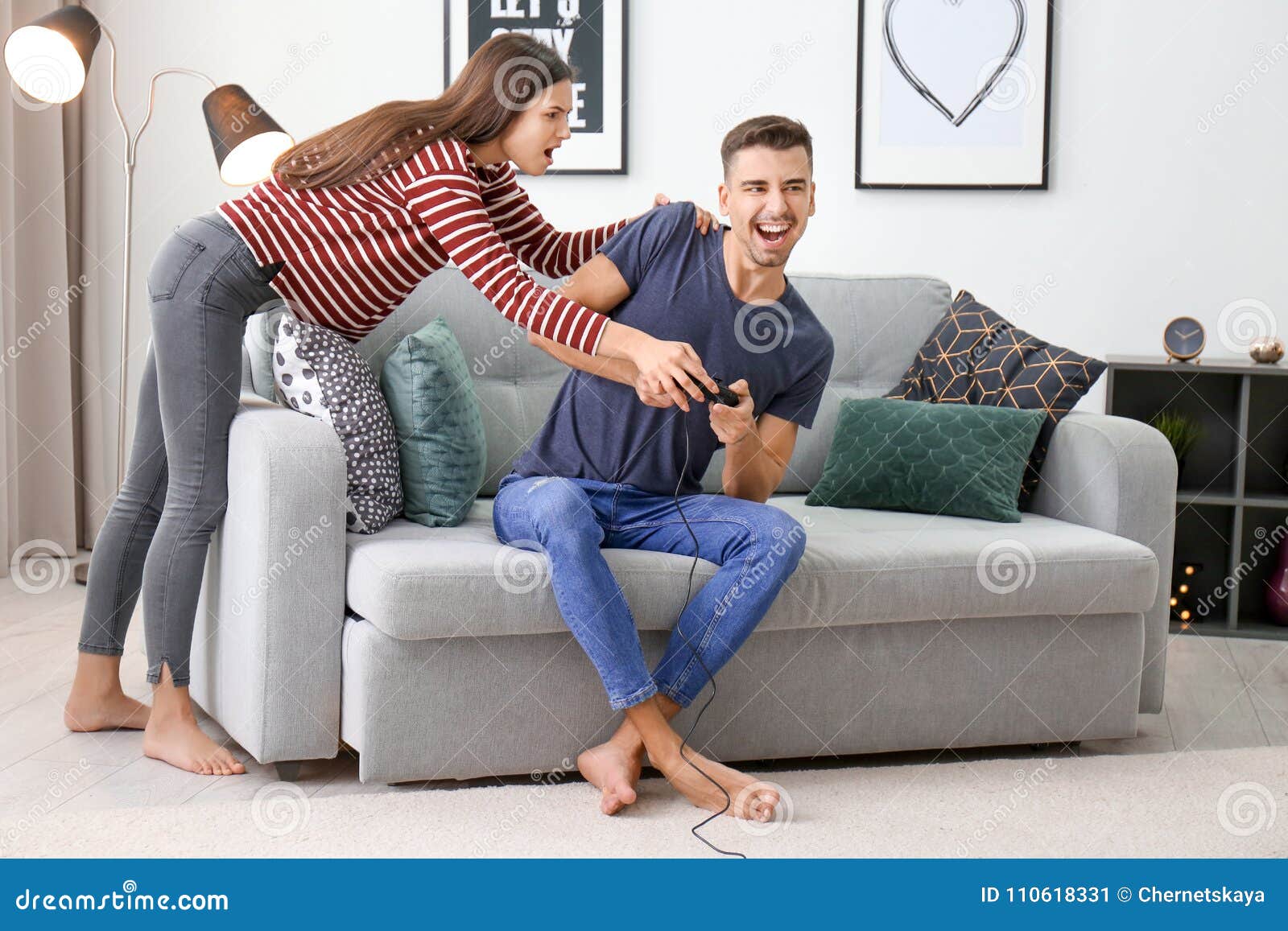 Young Couple Fighting for Joystick while Playing Video Games Stock ...