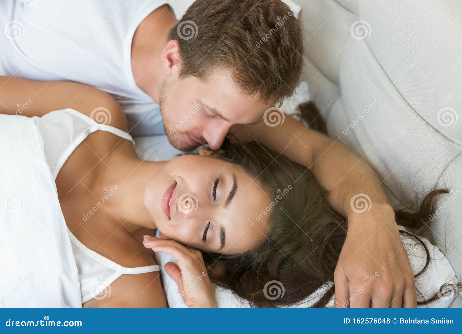 Young Couple Handsome Husband Kissing His Beautiful Sleeping Wife in Bed in Bright Bedroomfeeling Happy Family Morning Stock Photo