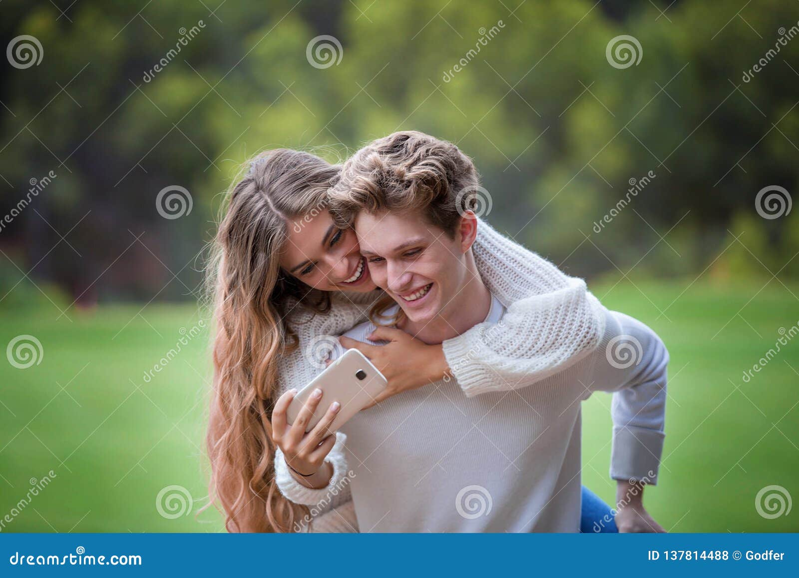 young couple smiling at camera selfie