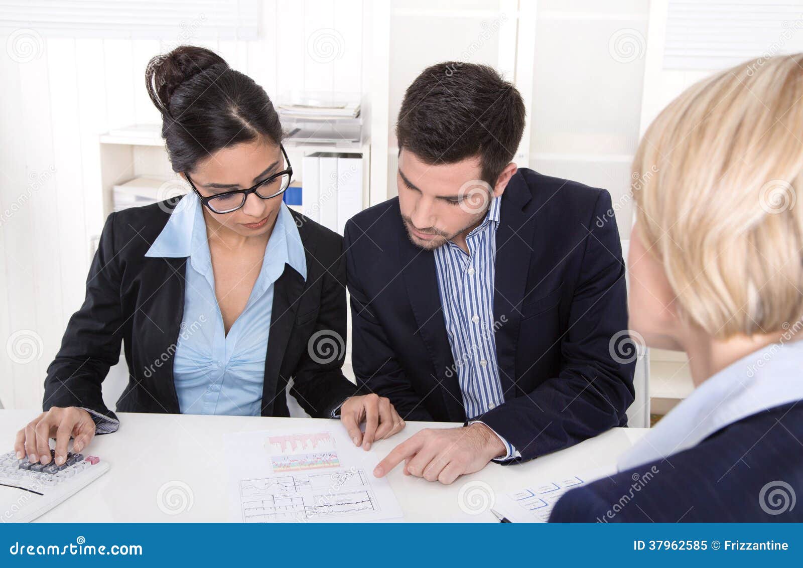 young couple has consultation with consultant at desk at office.