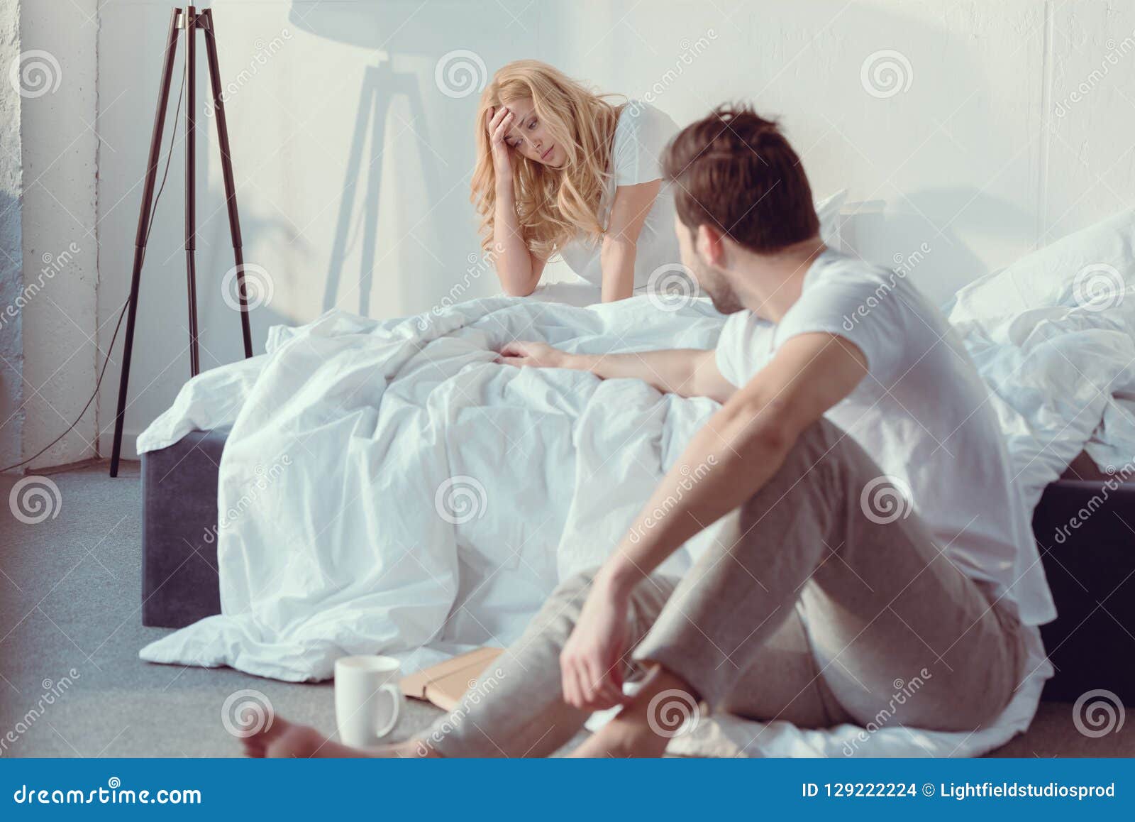 Young Couple Having Argument In Bedroom Stoc