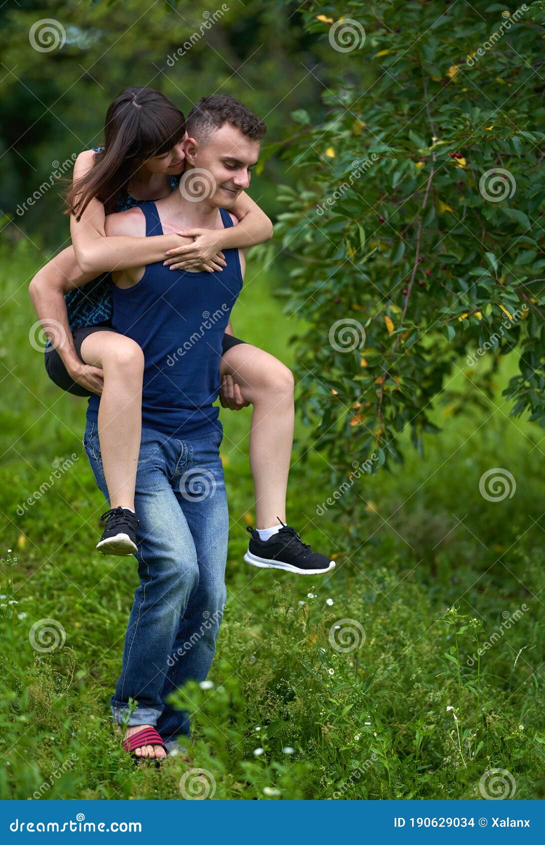 Young couple enjoying piggyback ride isolated on gray background Stock  Photo - Alamy