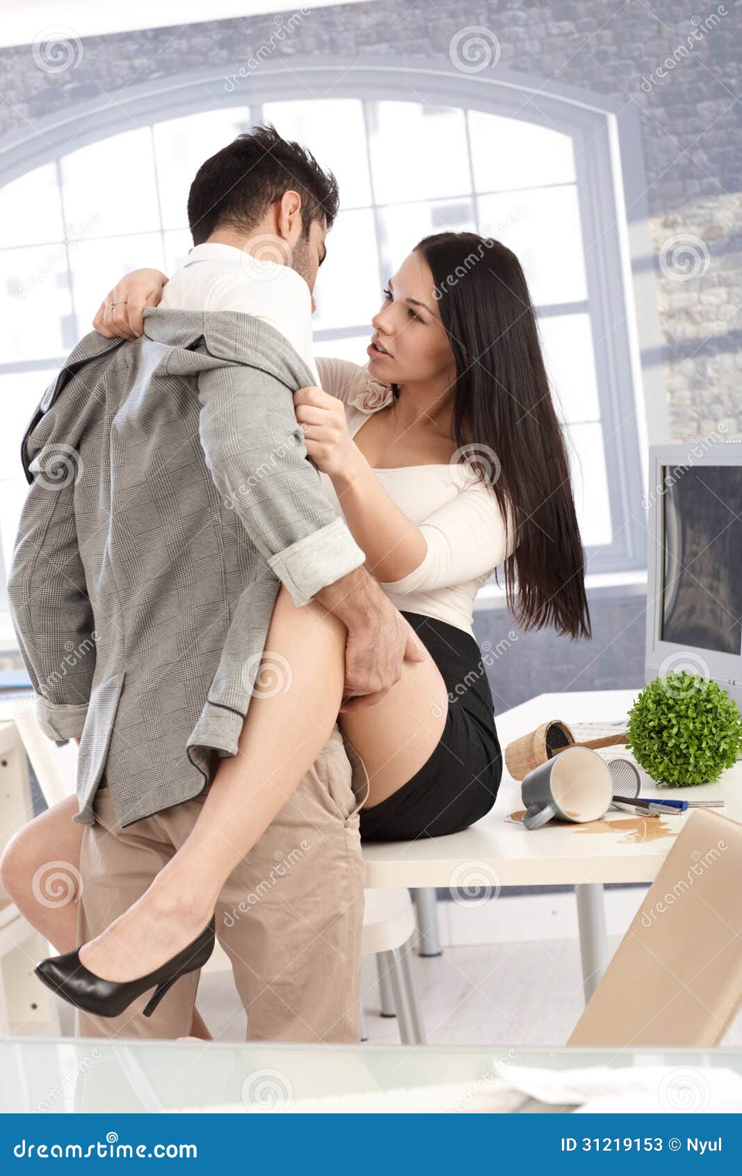 Young Couple Having Sex at Workplace Stock Image