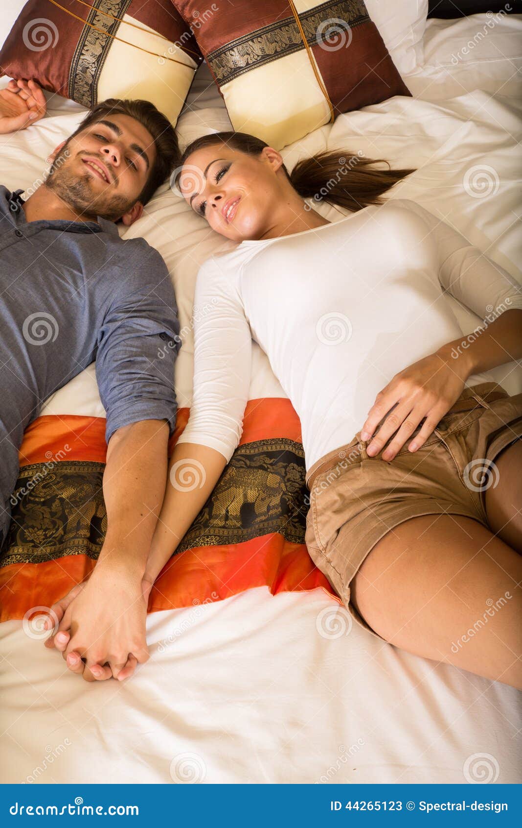 Young Couple Holding Hands In A Hotel Ro