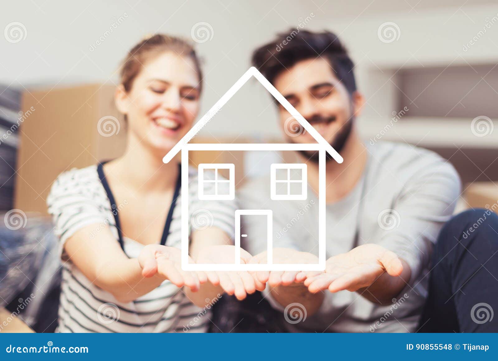 young couple holding their new, dream home in hands