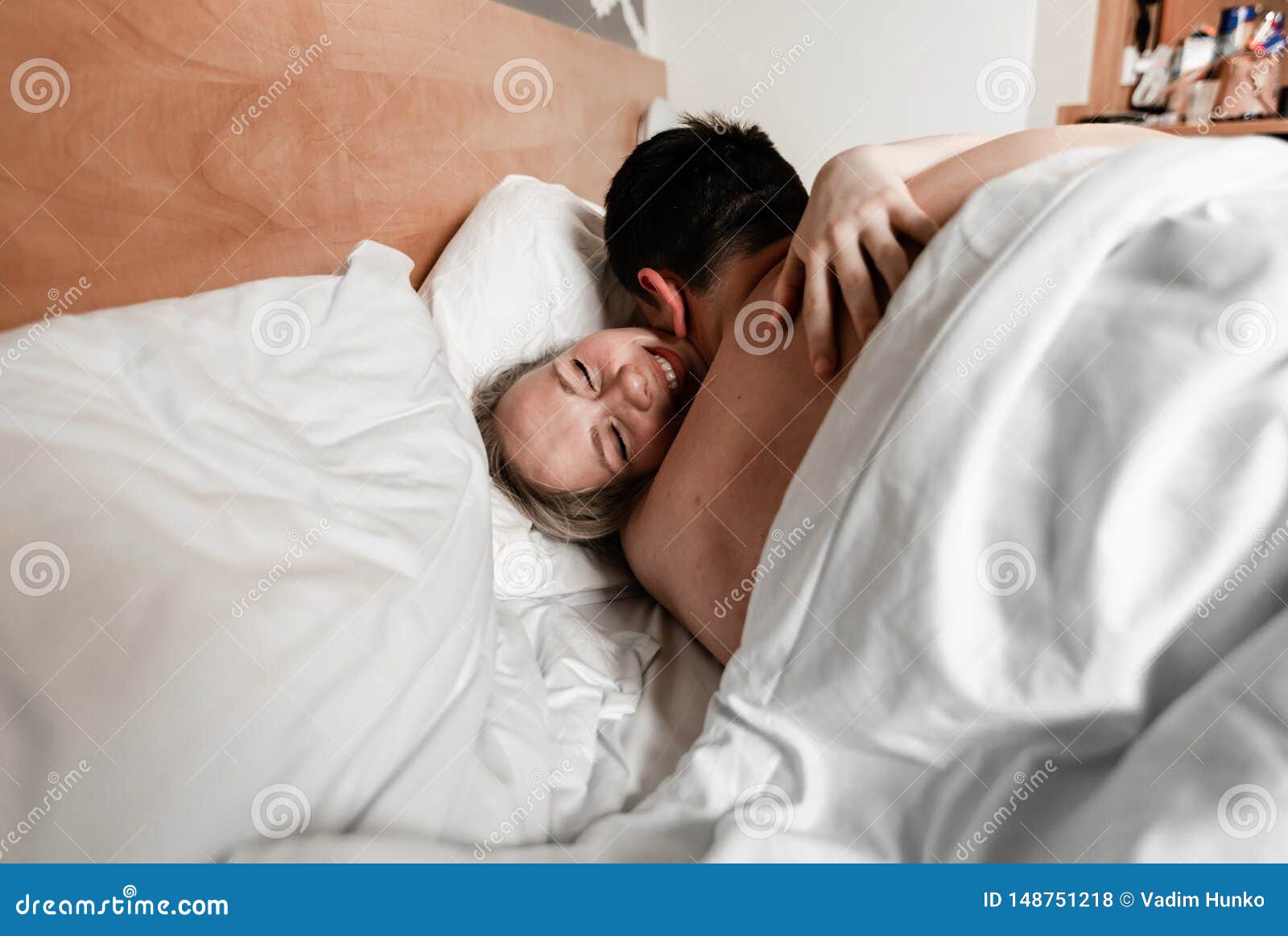Beautiful Happy Young Couple or Family Waking Up Together in Bed Stock Photo image pic