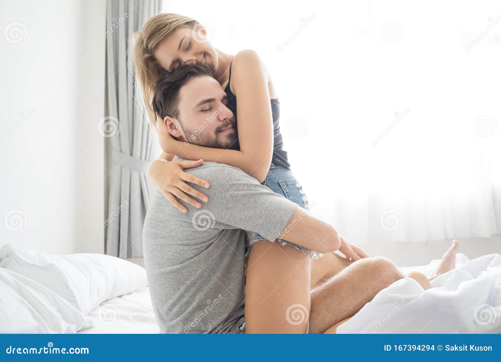 Young Couple Hugging in the Bed .loving Couple in Bedroom. Stock ...