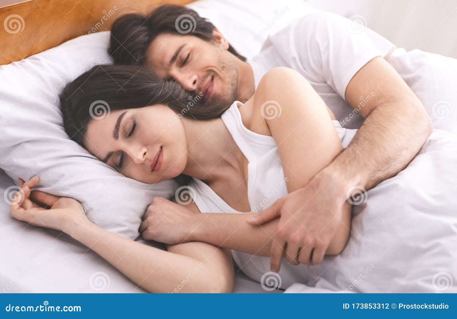 Young Couple Hugging, Sleeping Together in Family Bed Stock Photo - Image  of bedroom, couple: 173853312