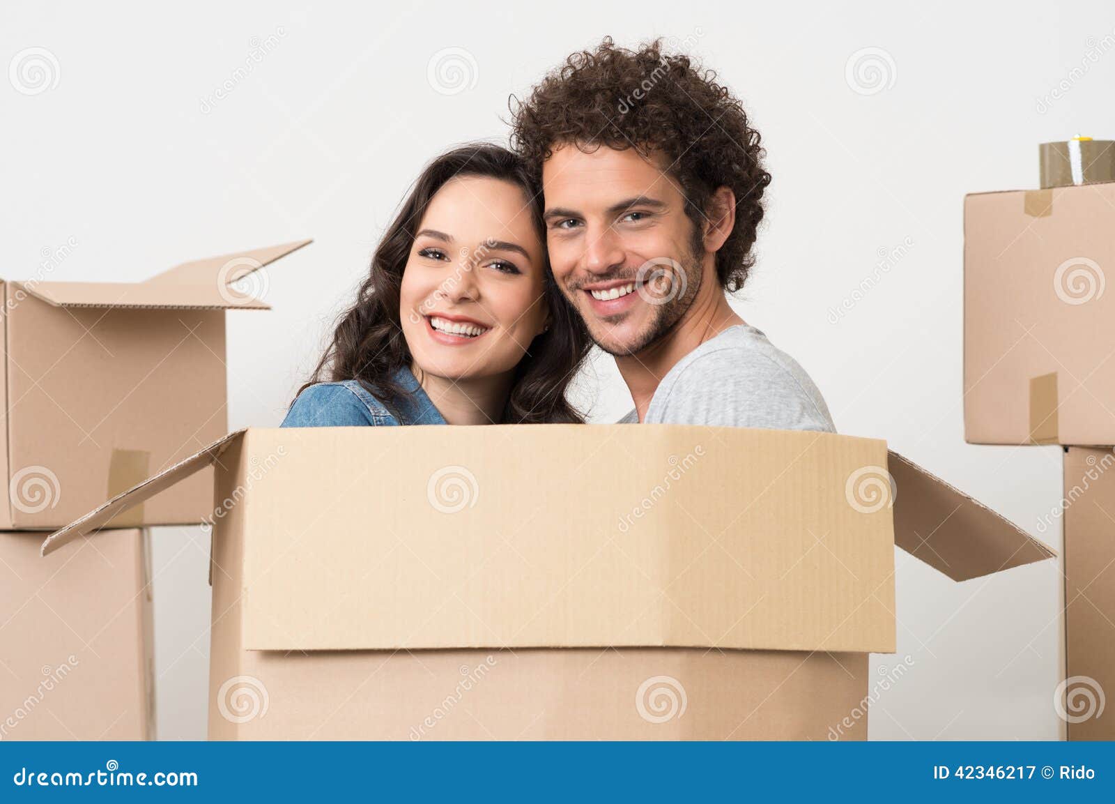 young-couple-inside-cardboard-box-smiling-happy-preparations-move-42346217.jpg