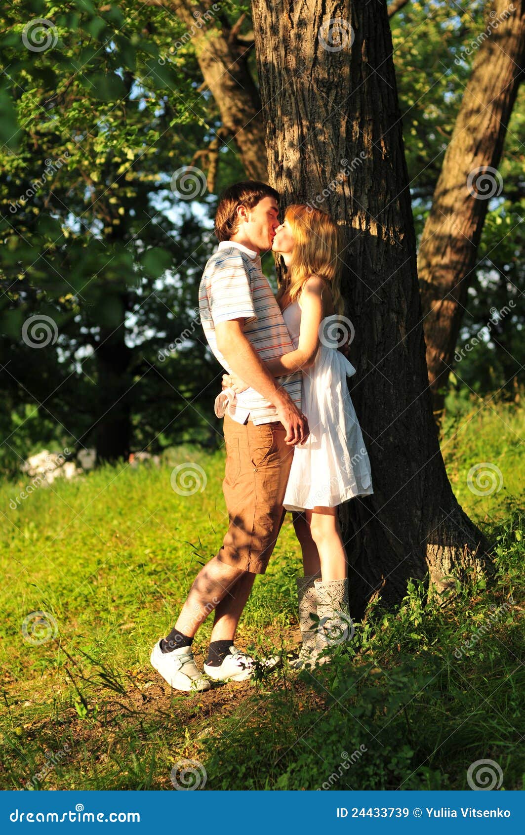 Young Couple Kiss Outdoors In The Forest Royalty Free Stock Images