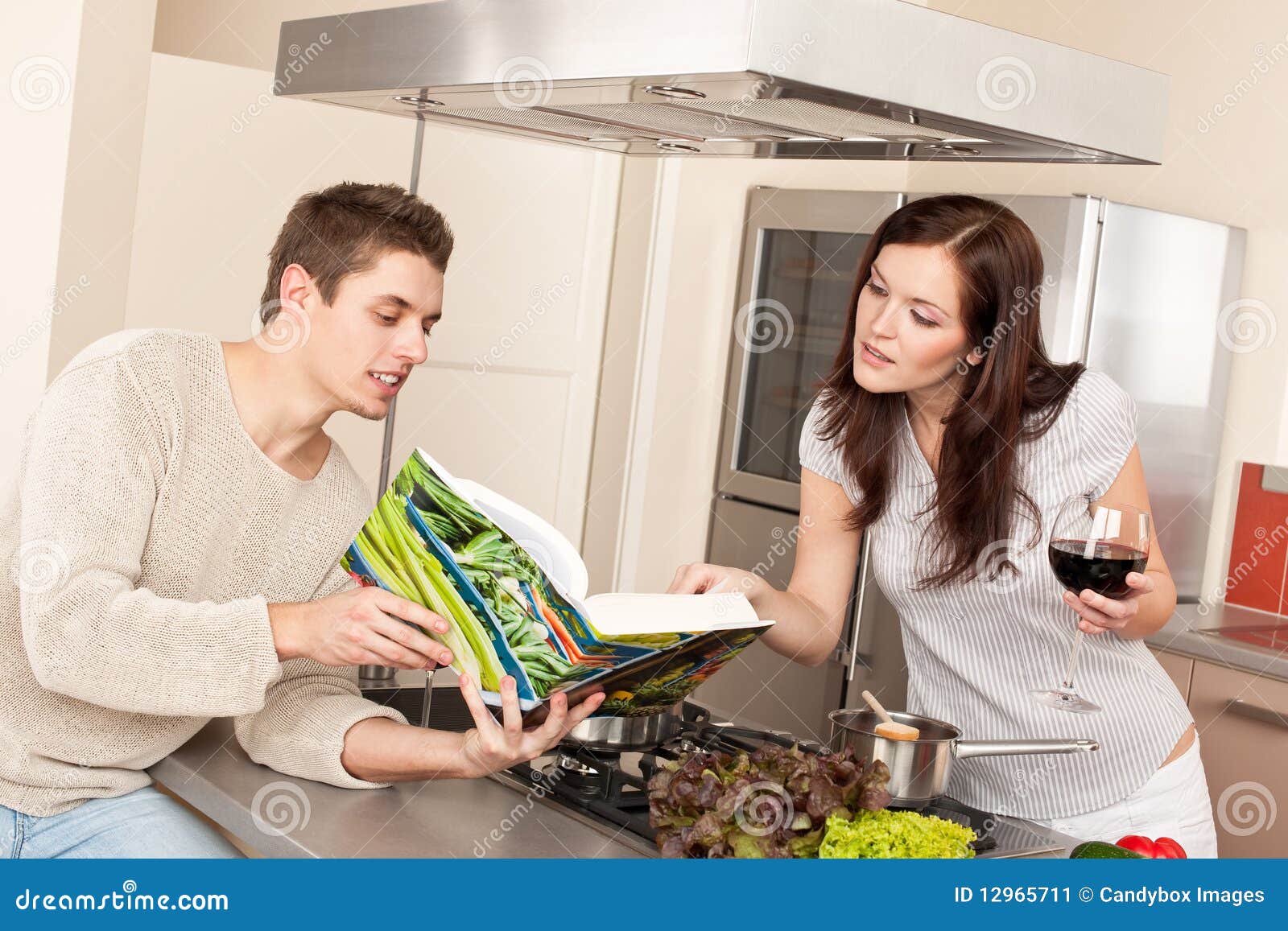 Young Couple in Kitchen with Cookbook Stock Image Image of young