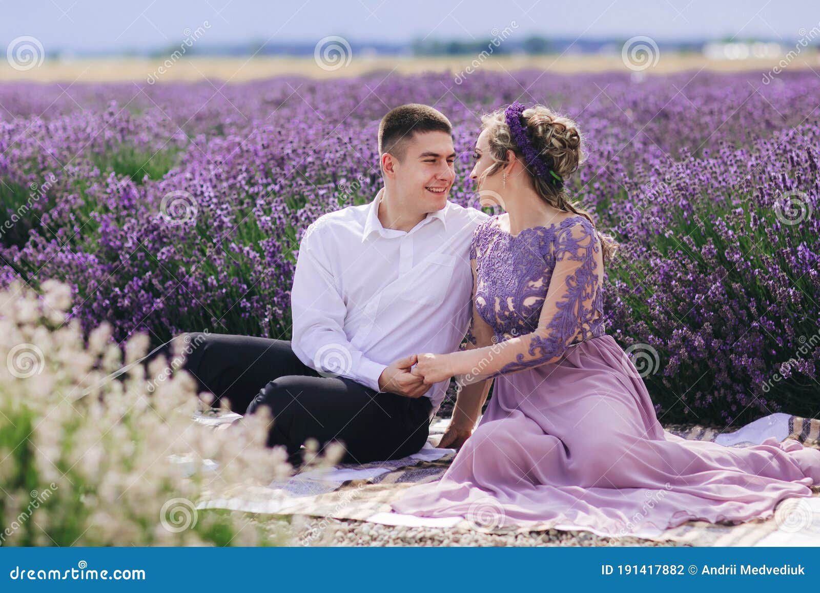 Young Couple in Love Hugging and Sitting in a Lavender Field on Summer  Clody Day. Girl in a Luxurious Purple Dress and with Stock Photo - Image of  flower, groom: 191417882