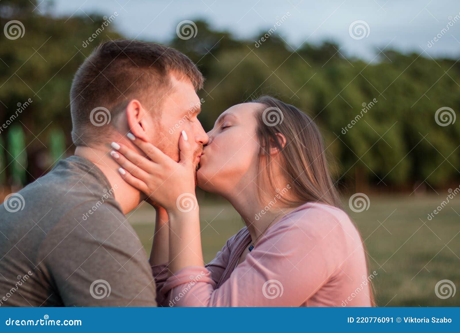 Young Couple in Love Sharing a Kiss at the Beach Stock Image photo