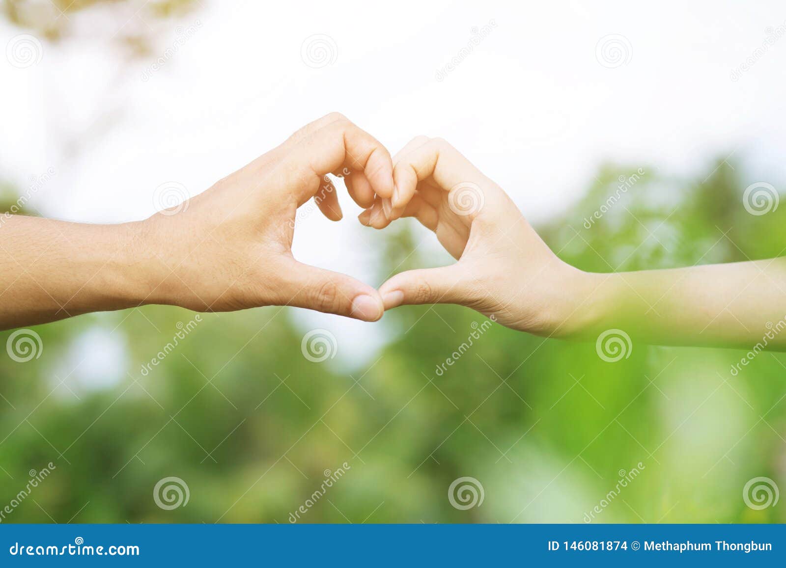 Young Couple Lover Show Holding Hands Make Heart Shape Over in Public Parks image