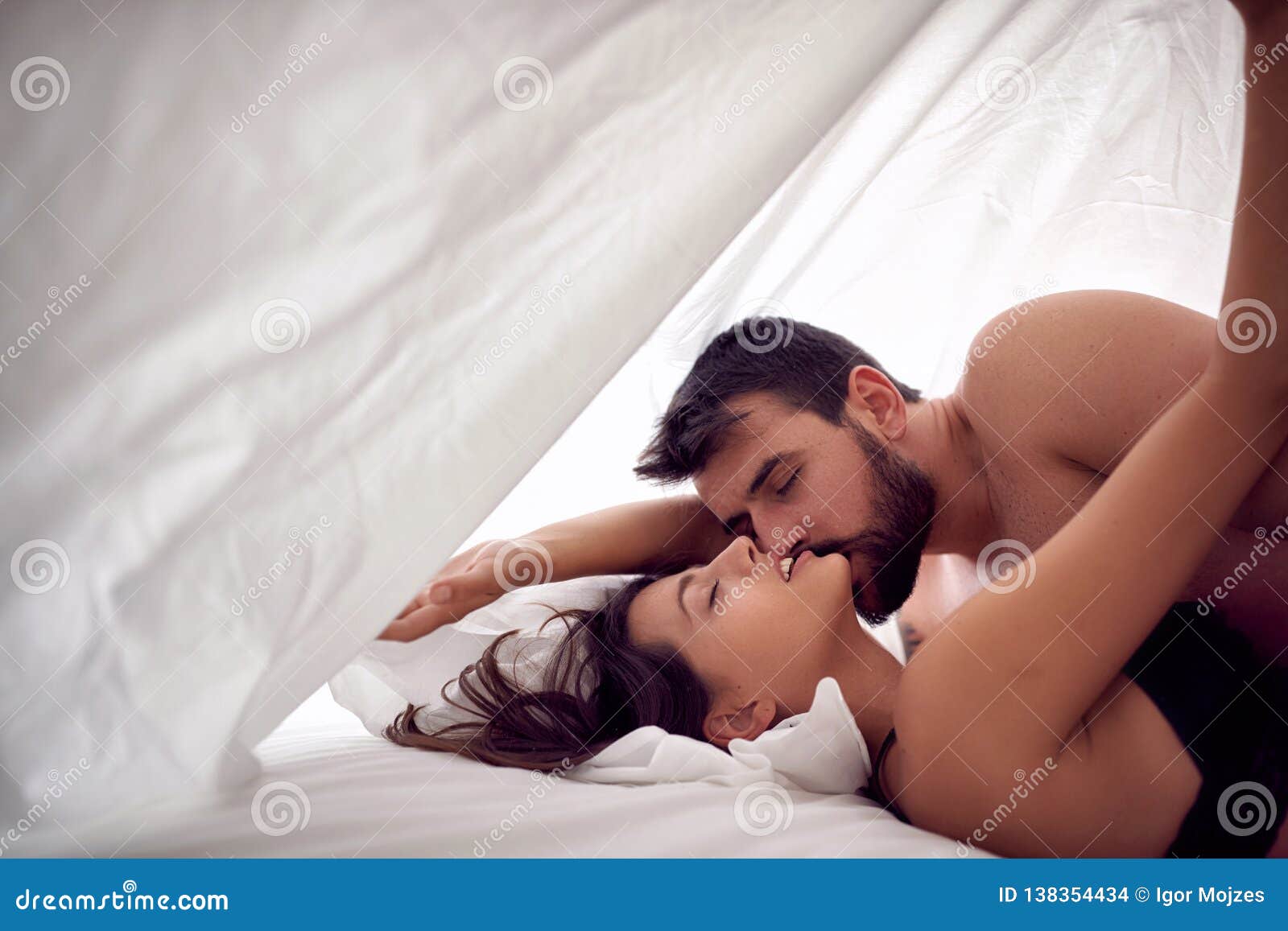 Couple Lovers Having Sex on a Bed in Morning with Lust and Love photo