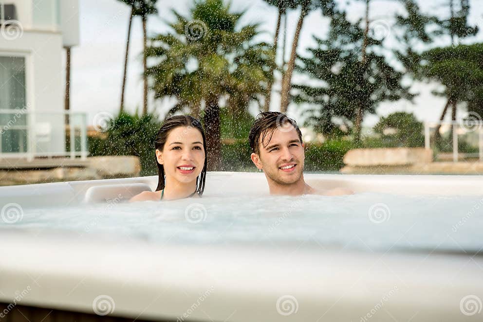 Young couple in a jacuzzi stock photo. Image of complicity 97416006
