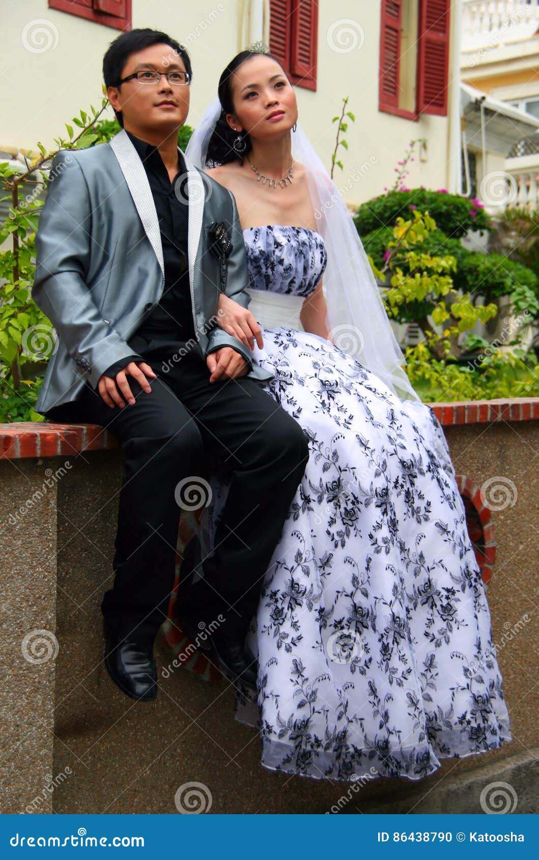 GULANGYU, CHINA - OCT 20, 2009: Young couple posing for wedding portfolio. Picturesque streets of the Gulangyu island are very popular among honeymooners