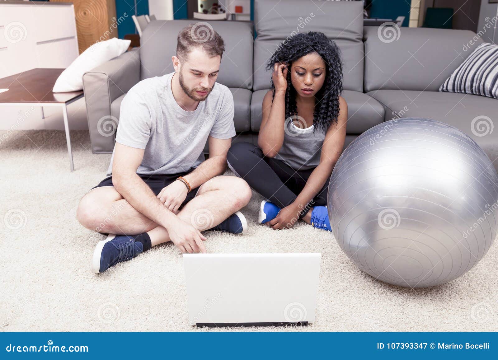 Young Couple Prepares Gymnastic Exercises On The Computer Stock Image