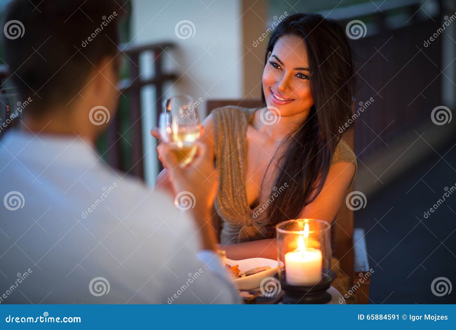 young couple with a romantic dinner with candles