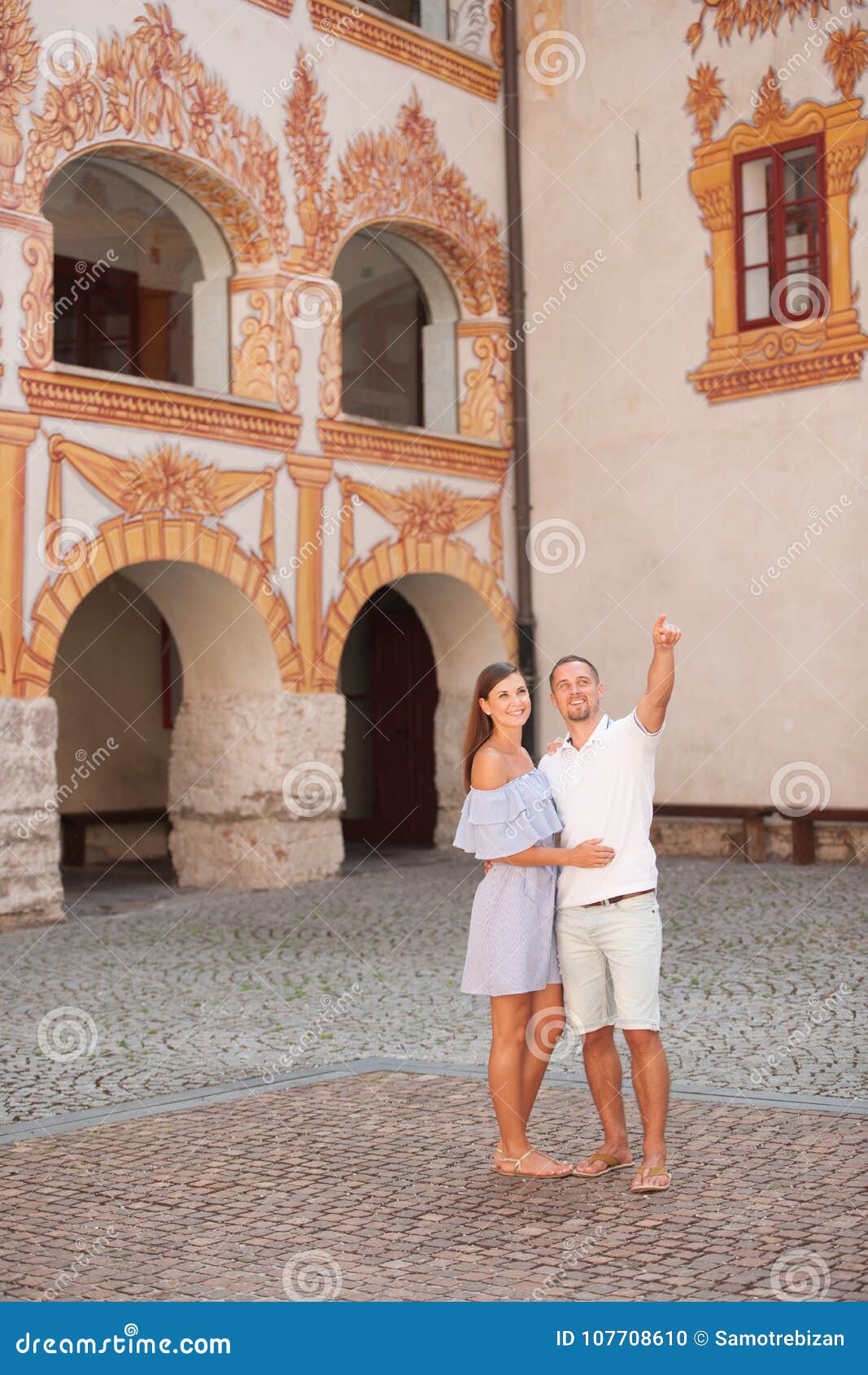young couple siteseeing on a hot summer afternoon on a paved street