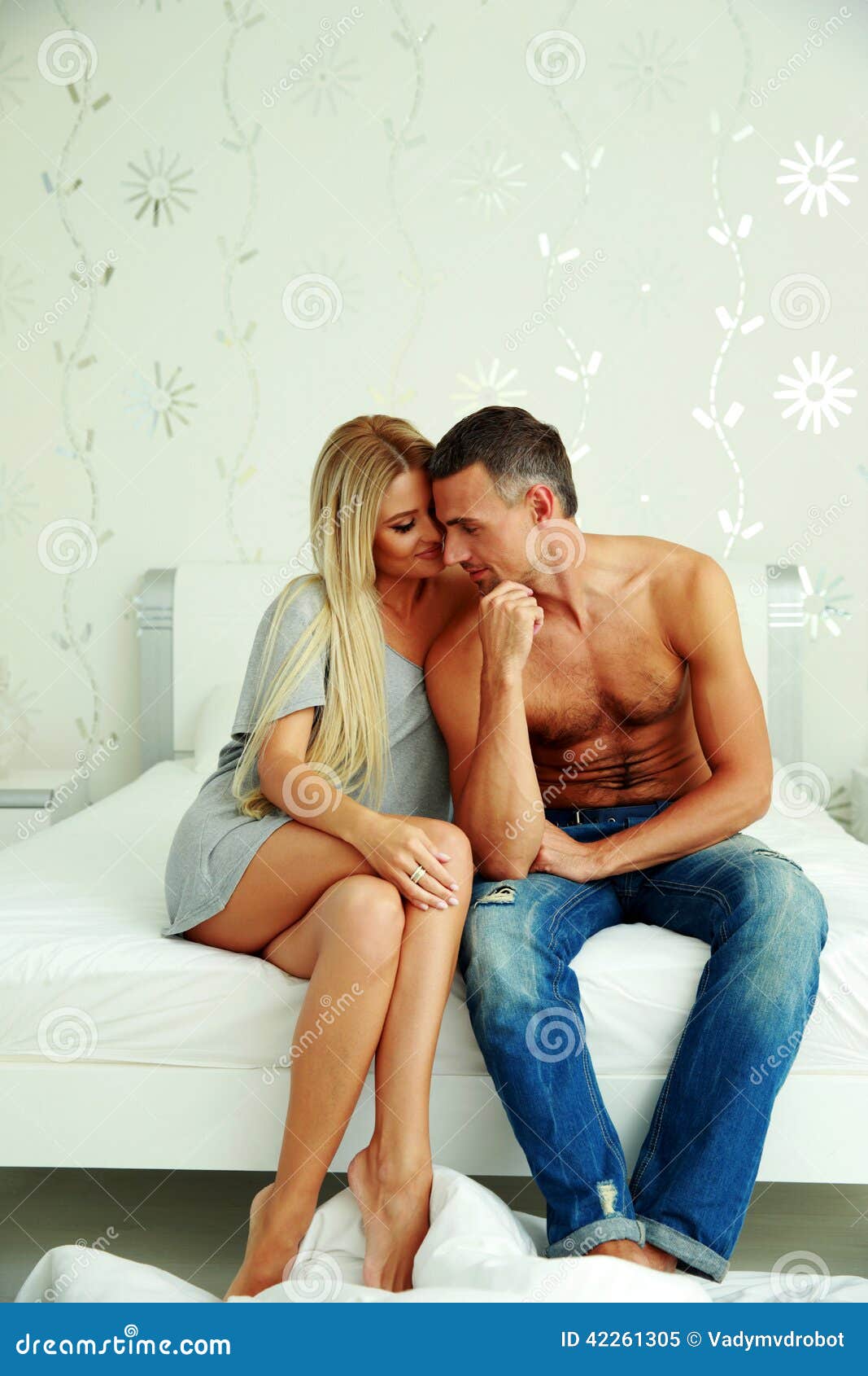 Young Couple Sitting On The Bed Stock I