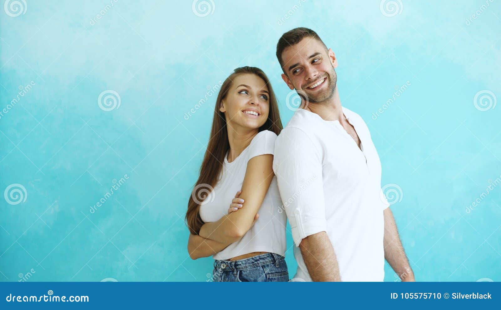 Young Couple Standing Back To Back Flirting Each Other on Blue ...