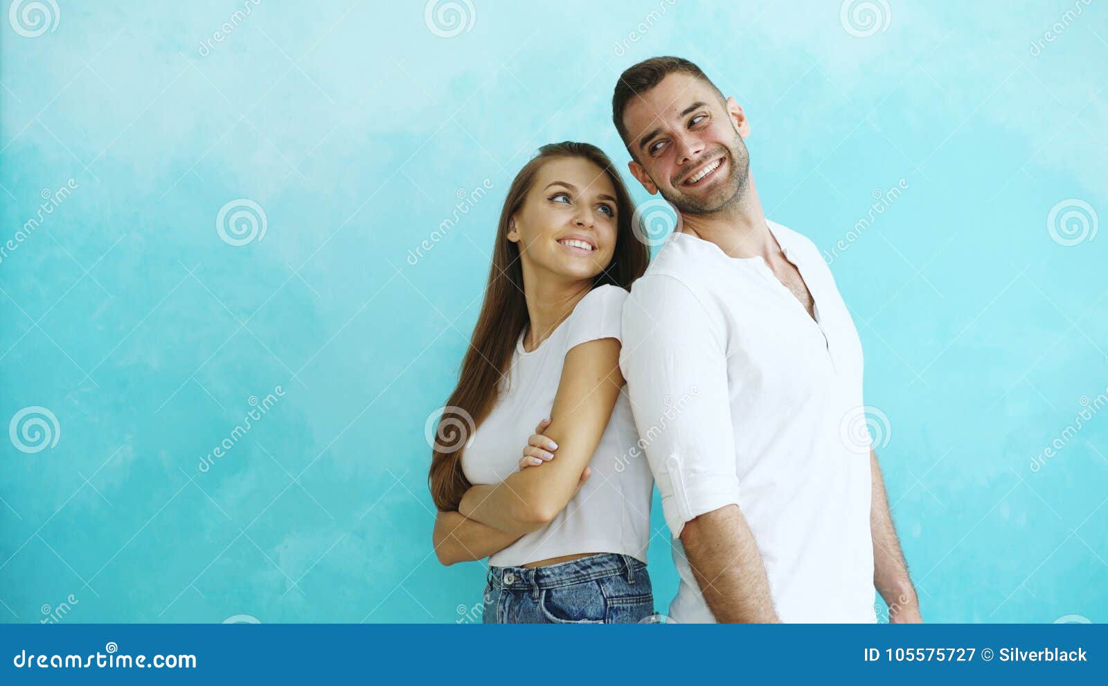 Young Couple Standing Back To Back Flirting Each Other on Blue ...