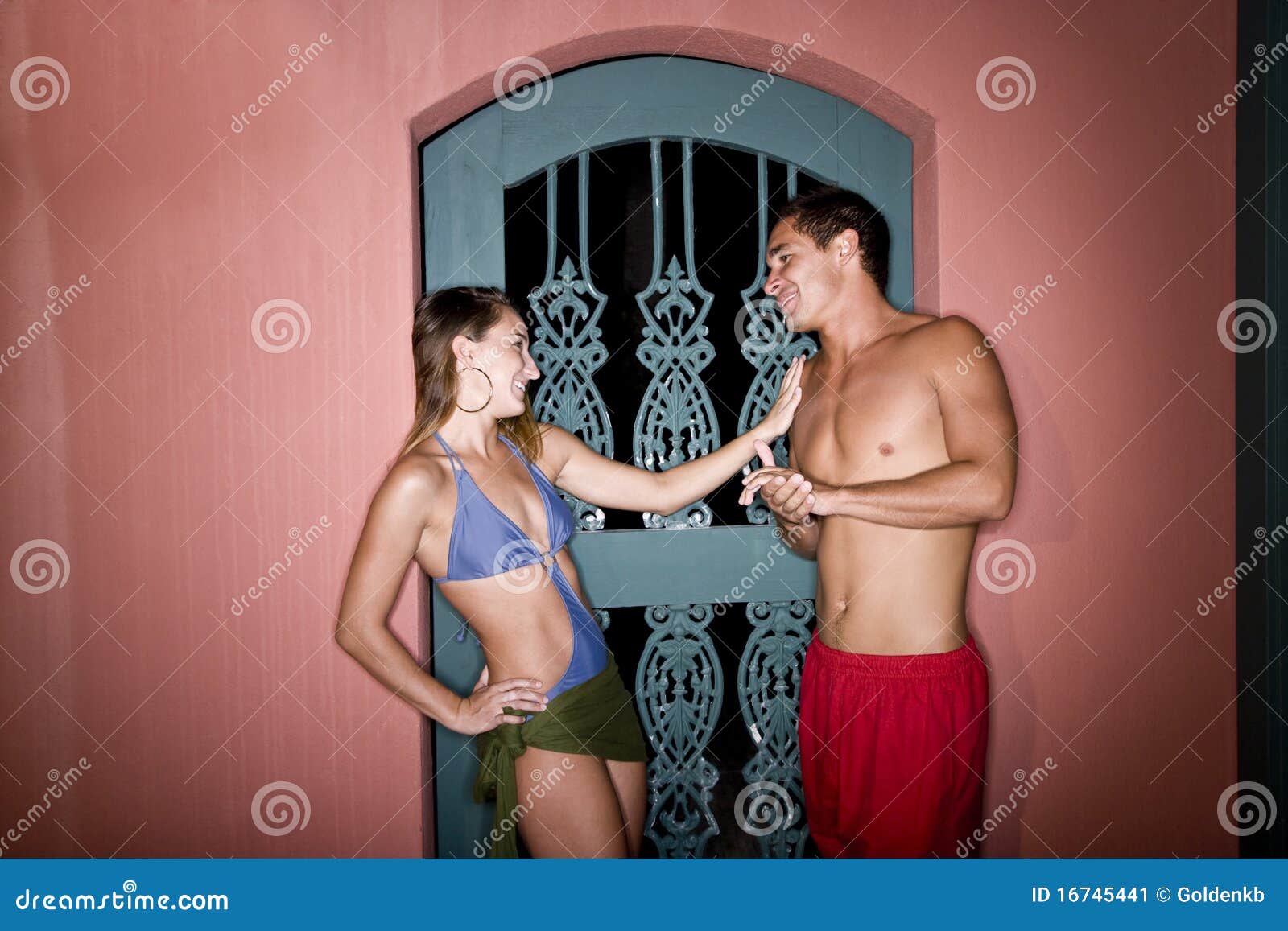 young couple in swimsuits flirting