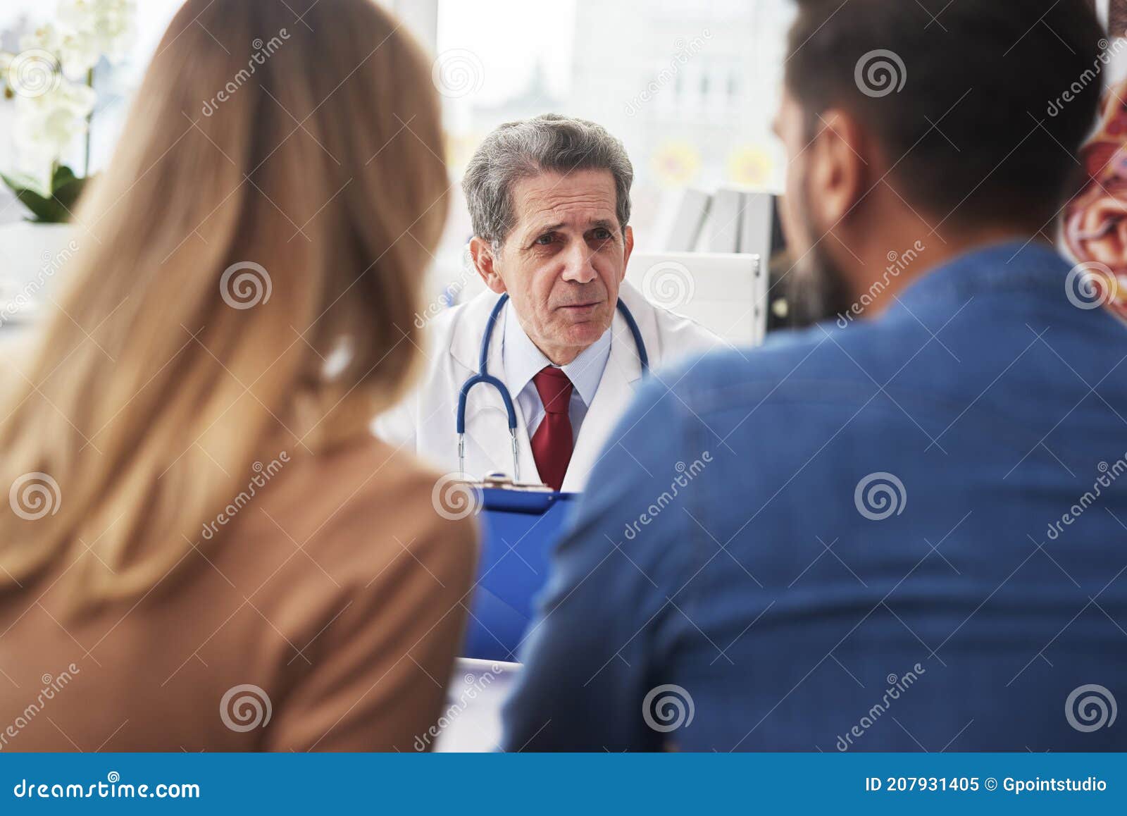 young couple talking with gynecologist in doctorÃ¢â¬â¢s office