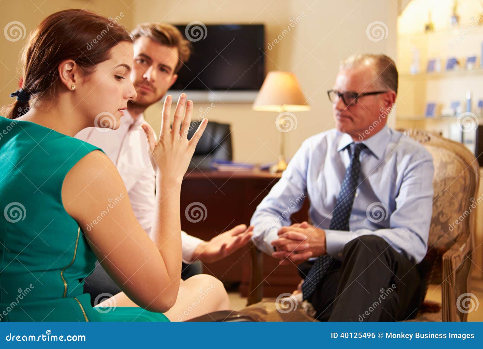 young couple talking to male counsellor