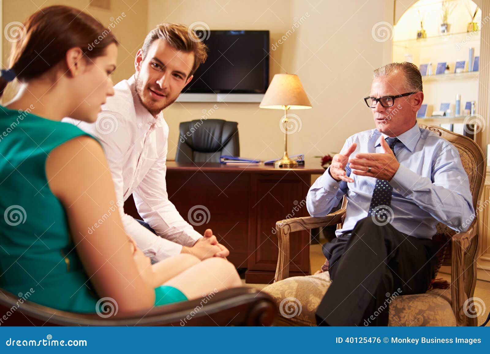 young couple talking to male counsellor