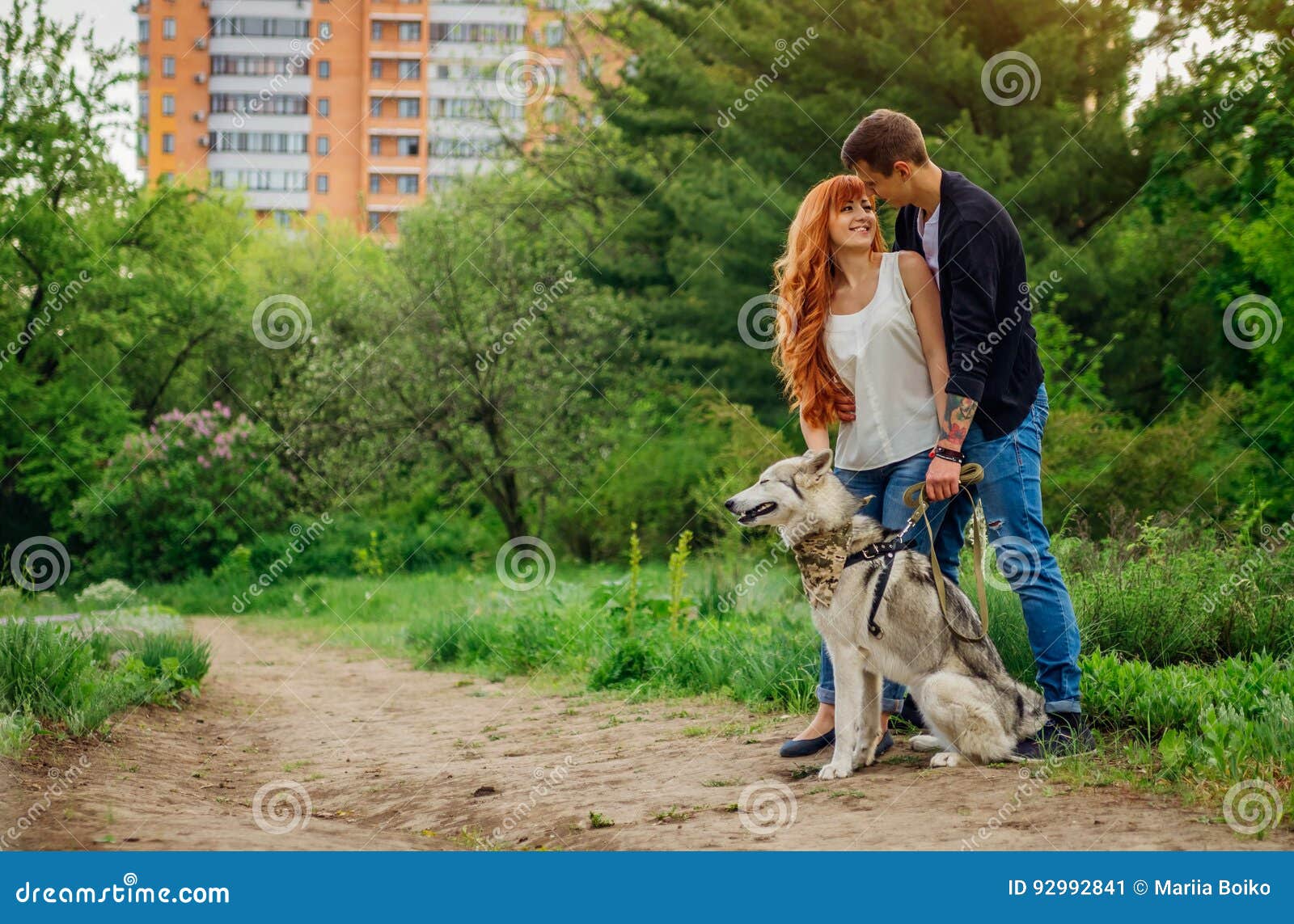 A Young Couple Walking a Dog in the Park Stock Image Image of cute, outside 92992841