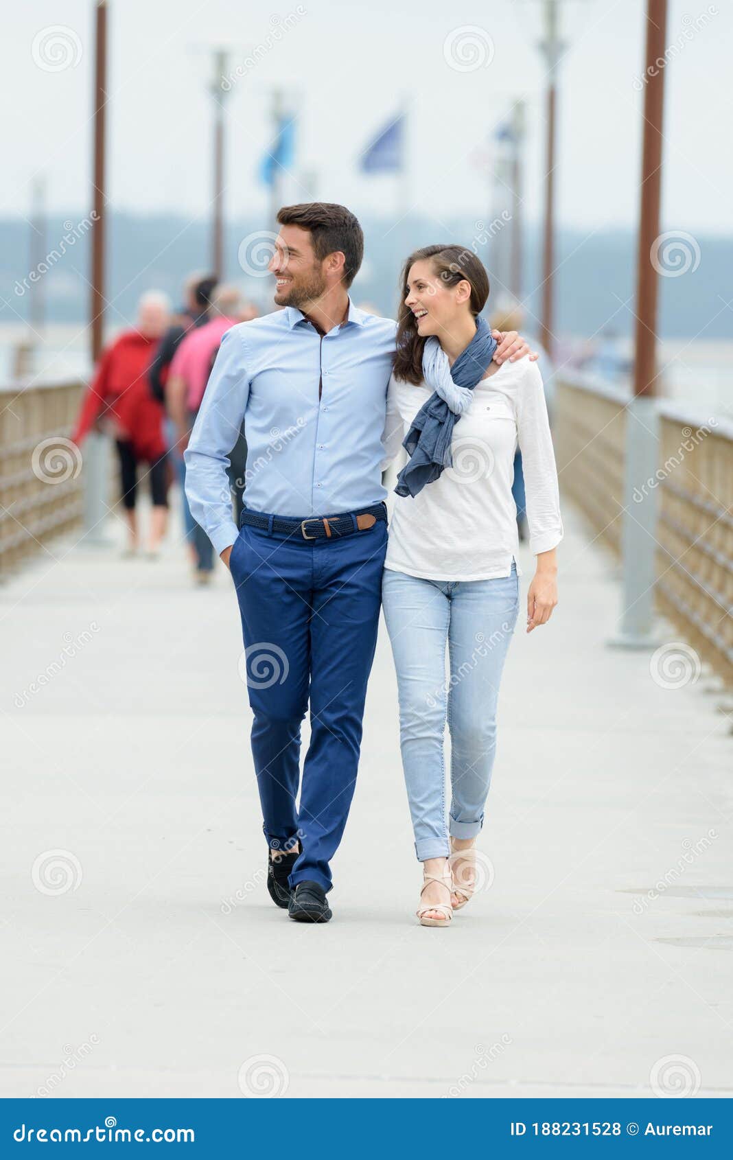 young couple walking on pier